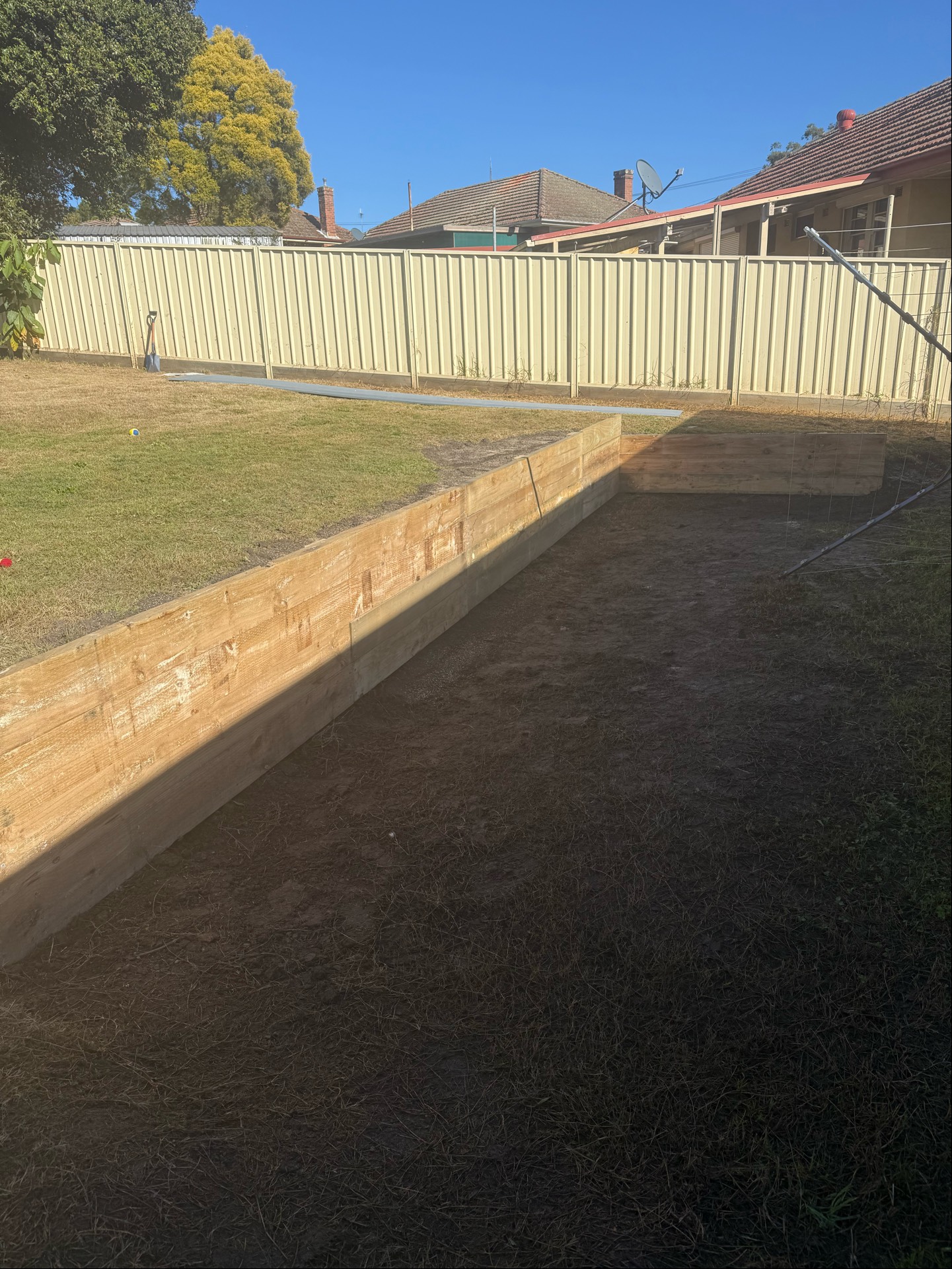 New timber retaining wall levelling a backyard in Hamilton
