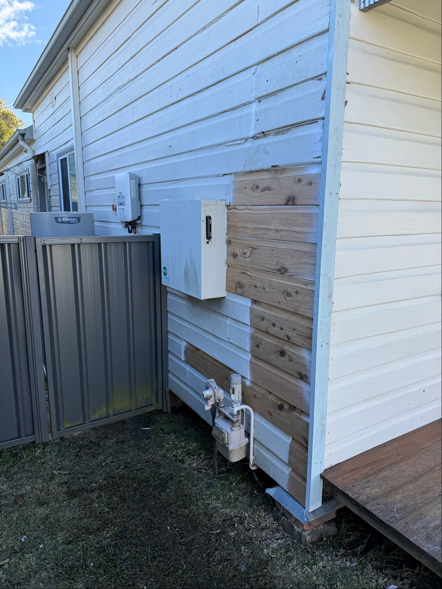 Weatherboard cladding repair showing new timber boards fitted to an existing wall